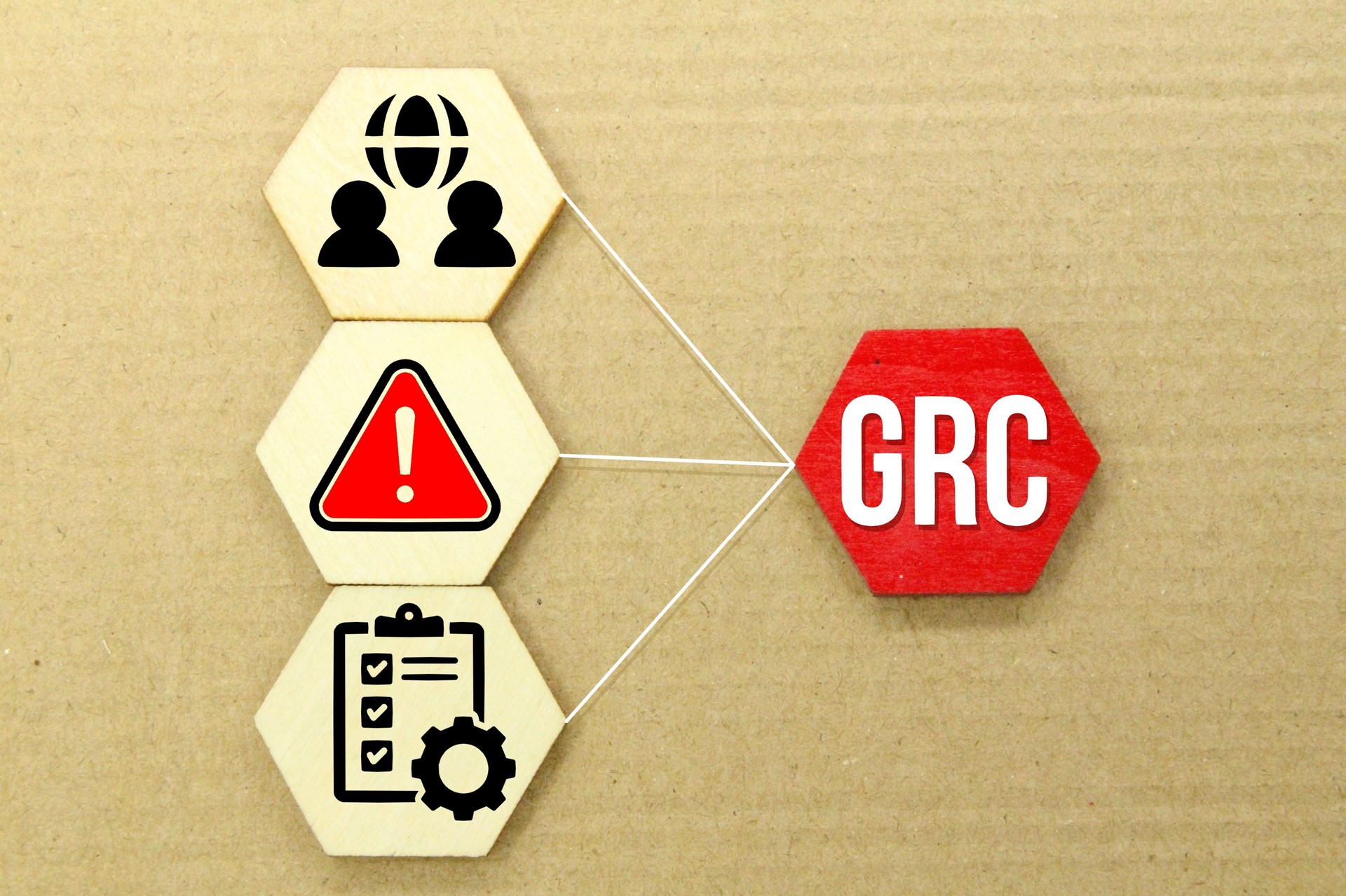 wooden hexagon with the Governance, risk management, and compliance icon or the letter GRC.